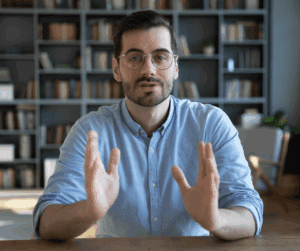 Man in blue shirt explain something on video